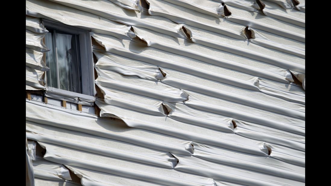 Melted siding on a home is seen near the scene of a train derailment in Lac Megantic, Quebec, July 7.