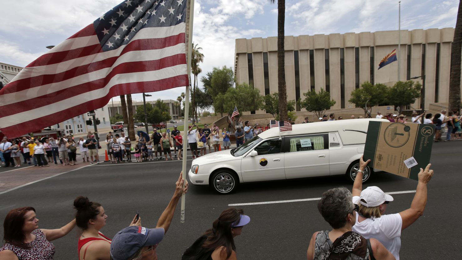 The bodies of 19 firefighters who died in the Yarnell Hill Fire are transported through Phoenix on July 7.