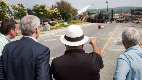 Canadian Prime Minister Stephen Harper, second left, observes the site of the explosion on Sunday, July 7.