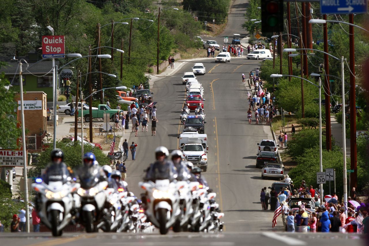 Nineteen white hearses carried the remains of the firefighters on July 7. They were accompanied by police motorcycle outriders on a final journey passing through the crew's hometown.
