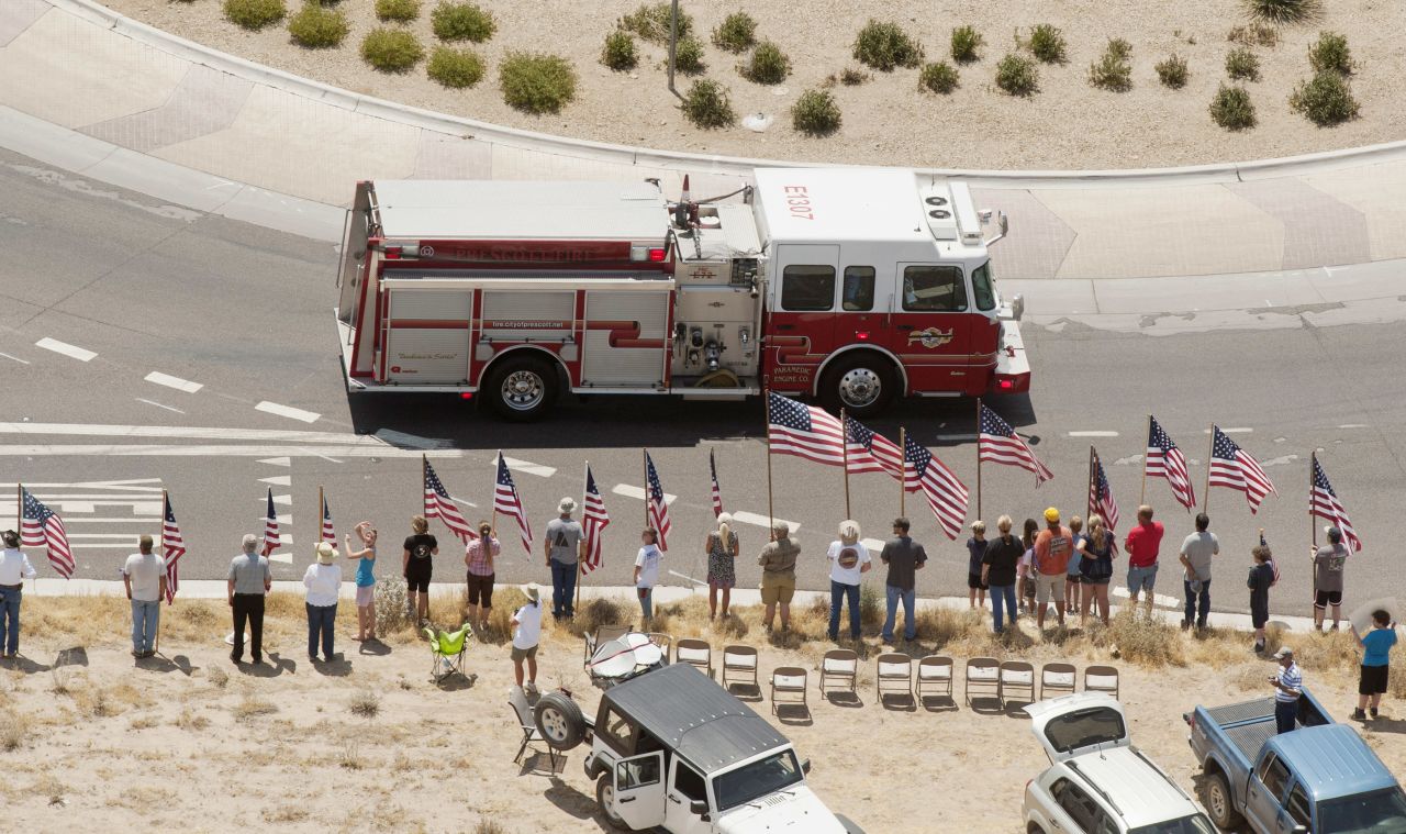 A fire truck travels as part of the procession under escort by the Joint Arizona Honor Guard.