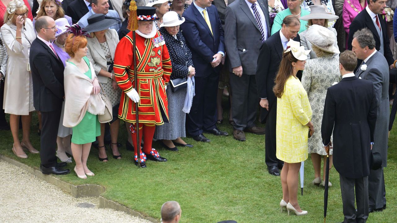 The Duchess speaks with guests as she arrives at a garden party on the grounds of Buckingham Palace in London on May 22.
