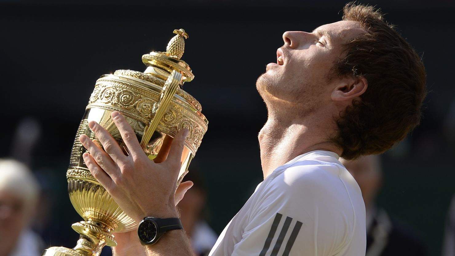 Britain's Andy Murray holds the winner's trophy after beating Serbia's Novak Djokovic in the men's singles final at the Wimbledon championships.