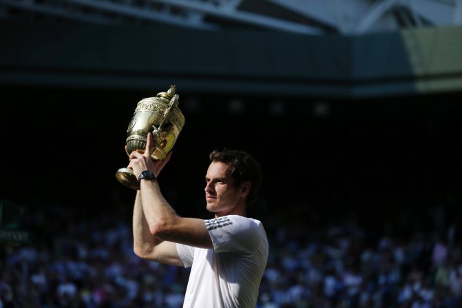 JULY 8 -  LONDON, GREAT BRITAIN: <a href="http://cnn.com/2013/07/07/sport/tennis/tennis-wimbledon-murray-djokovic">Britain's Andy Murray</a> poses with the winner's trophy after beating Serbia's Novak Djokovic in the men's singles final. Murray won the match 6-4, 7-5, 6-4, becoming the first British man to take the title in 77 years.