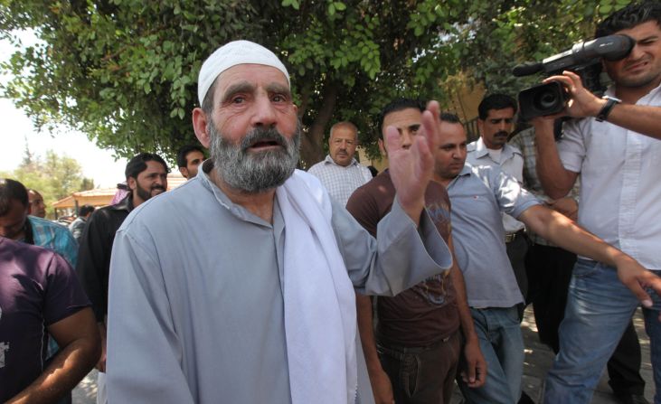 Mahmoud Othman Omar, front, father of Abu Qatada, speaks to the media after his son leaves the State Security Court in Amman July 7.