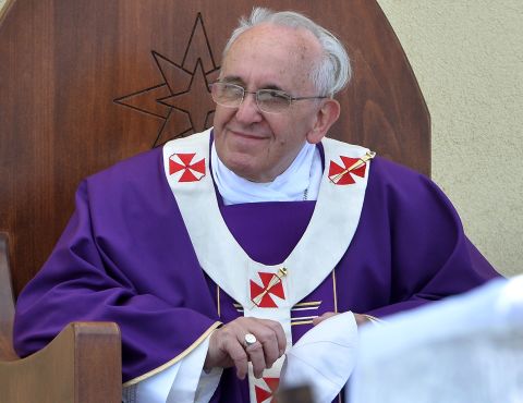 The pope held a mass for 15,000 people under blazing sun at an outdoor sporting center on the island. Standing at an altar made of the wooden remnants of refugee boats and dressed in purple robes normally reserved for lent and mourning, Pope Francis gave an emotional homily focused on "global indifference" to the refugee and irregular migrant problem.