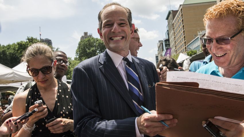  	NEW YORK, NY - JULY 08: Former New York Gov. Eliot Spitzer collects signatures from citizens to run for comptroller of New York City on July 8, 2013 in New York City. Spitzer resigned as governor in 2008 after it was discovered that he was using a high end call girl service. (Photo by Andrew Burton/Getty Images) 