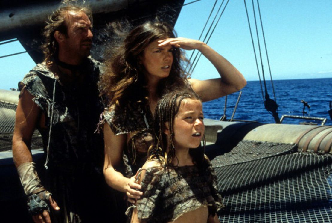 An image from "Waterworld" shows Kevin Costner as the Mariner, Jeanne Tripplehorn as Helen and Tina Majorino as Enola.