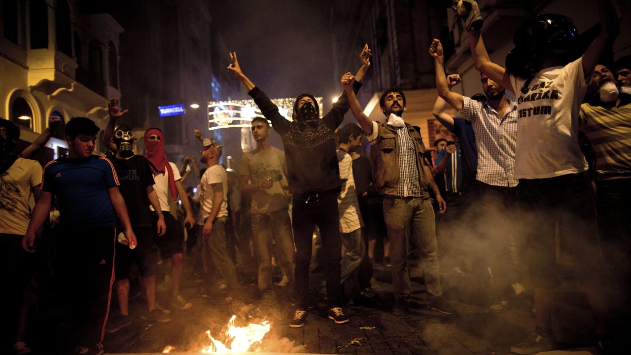 Turkish protesters shout slogans next to a bonfire during a protest on Istiklal Avenue in Istanbul on July 8, 2013. 