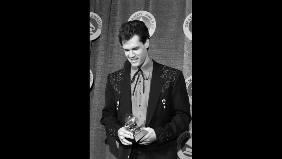 Travis poses for photos after winning the Grammy for Best Male Country Vocal Performance in 1988.