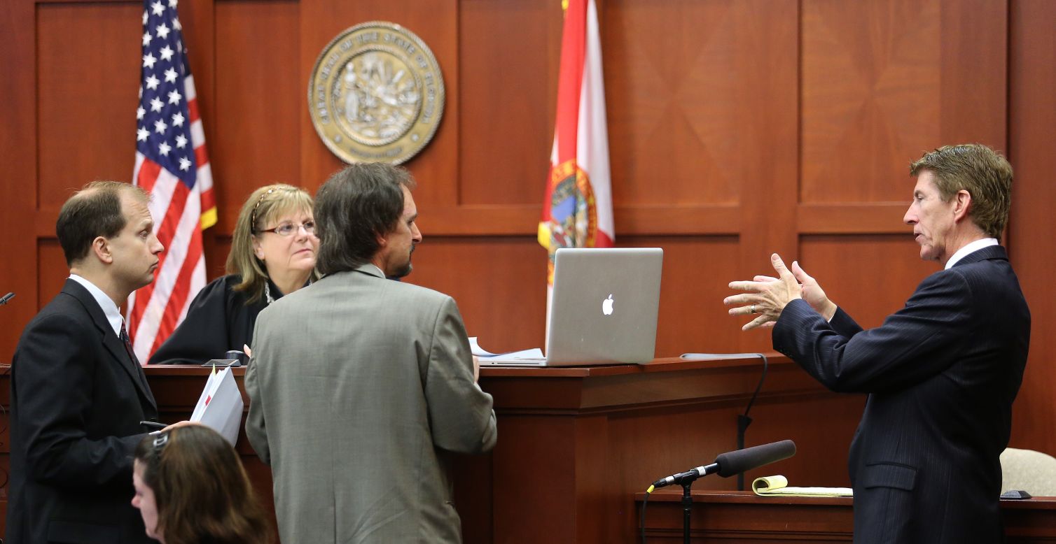 Defense attorney Mark O'Mara, right, questions forensics animation expert Daniel Schumaker, center, at the bench of Judge Debra Nelson with Assistant State Attorney Richard Mantei, left, during a July 9 hearing on the admissibility of animation created for the defense. Schumaker showed the judge and Mantei some 3-D animation on his laptop after an overhead projector didn't work.