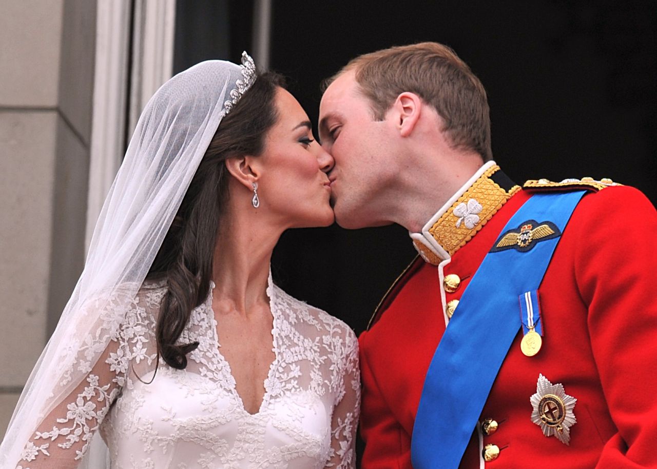 William and Catherine kiss on the balcony of Buckingham Palace after their wedding ceremony in London. 
