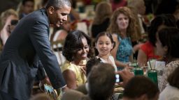 President Barack Obama and first lady Michelle Obama chat with guests during the second kids' "state dinner" on Tuesday, July 9, at the White House. Fifty-four children, along with their parents and guardians, attended as winners of the Healthy Lunchtime Challenge.  