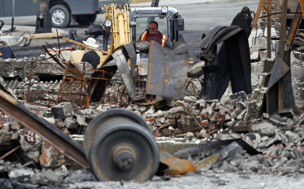 An emergency worker works at the site of the train wreckage on July 9.