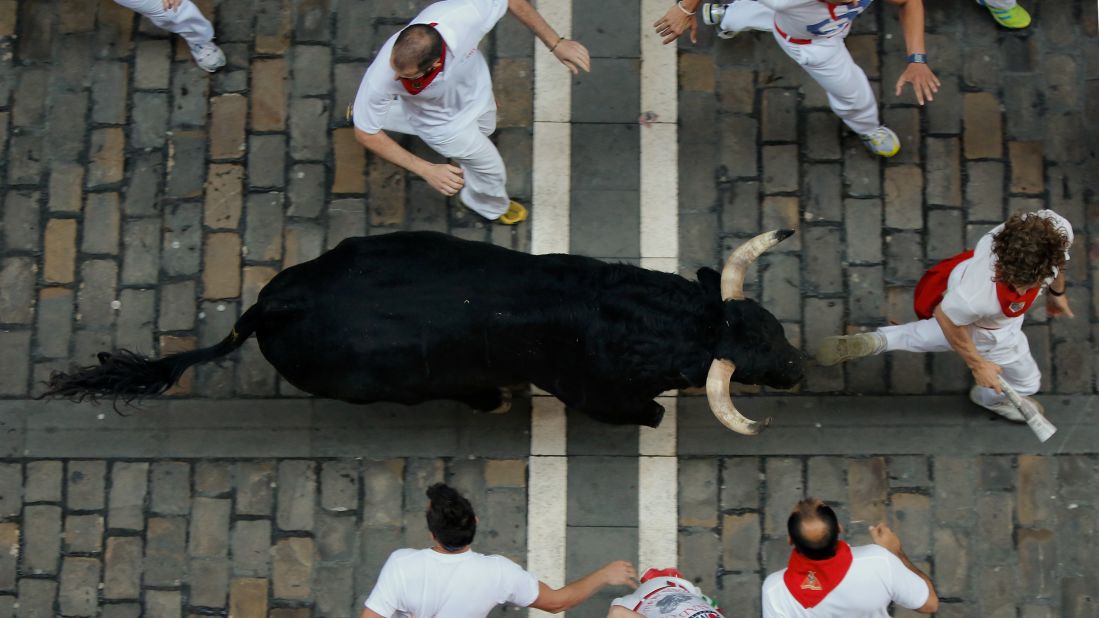 Participants run alongside a fighting bull in Pamplona on July 9. 