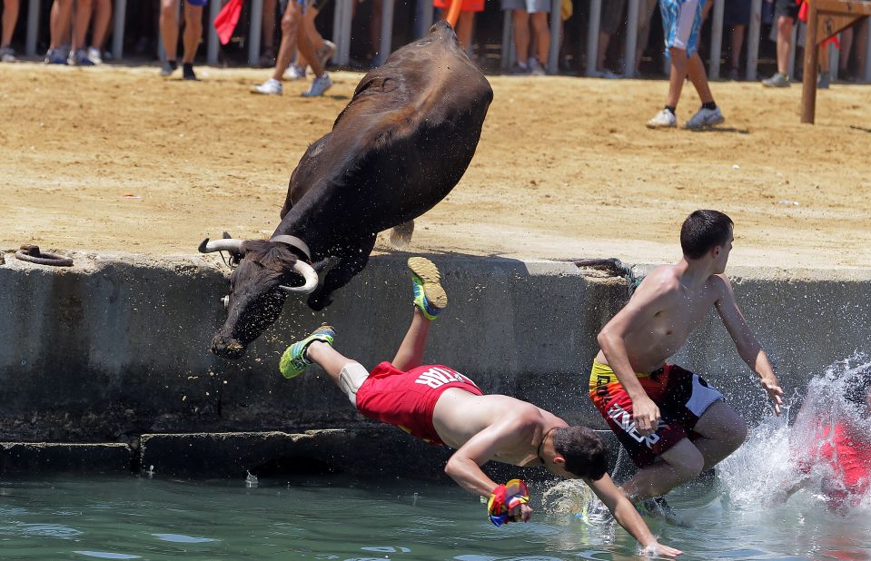 People leap into the water during the traditional "bous a la mar," or bull in the sea, event at Denia harbor near Alicante on July 8.