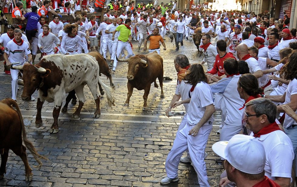 Participants run alongside bulls on Sunday, July 7. Each run lasts just a few minutes.