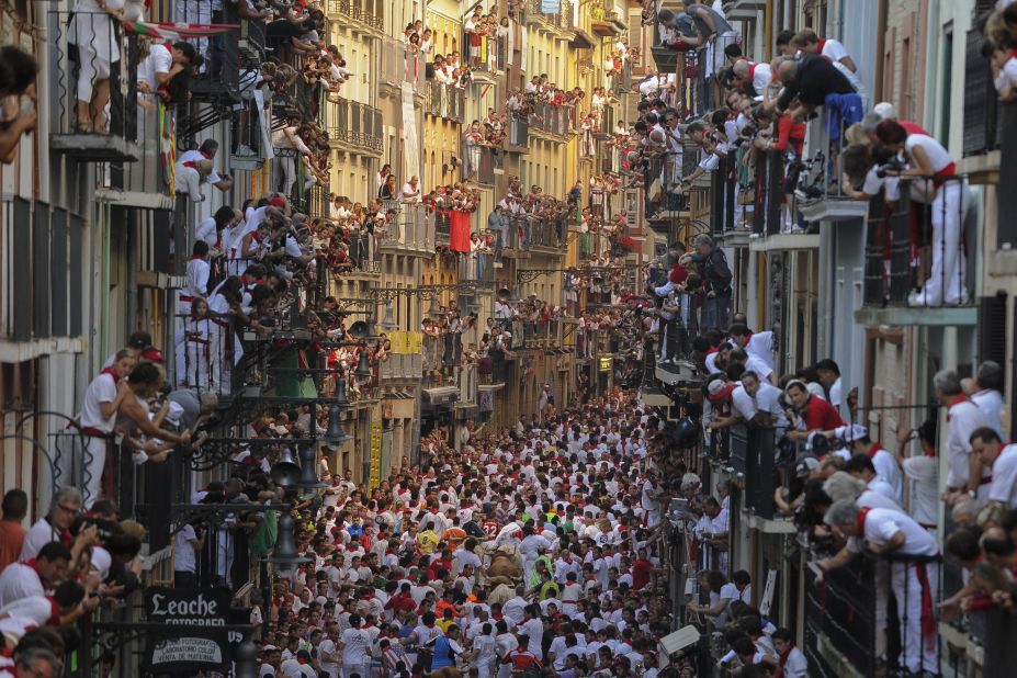 People watch the festivities from balconies on July 7. The annual event has become a popular symbol of Spanish culture, attracting thousands of tourists a year.