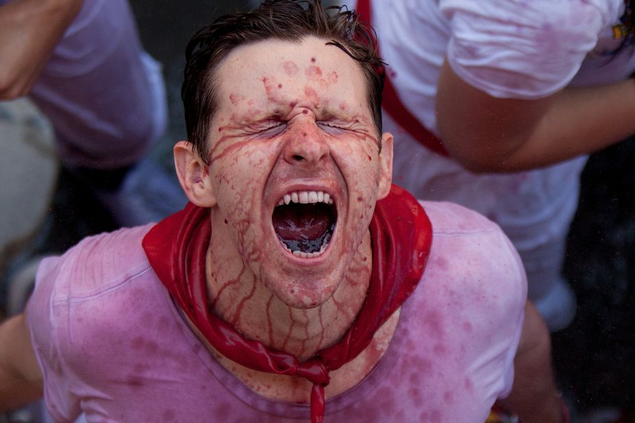 A man is sprayed with wine as revelers celebrate on Saturday, July 6, the opening day of the San Fermin festival.