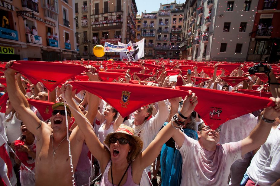 People hold up their red handkerchiefs during the opening ceremony on July 6.