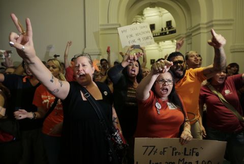 Opponents of the bill yell outside the Texas House after the bill was provisionally approved.