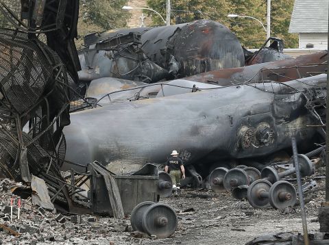 A police officer surveys the damage. At least 15 people were killed and another 45 remain missing after the weekend crash, authorities said. Those still missing are feared dead, possibly vaporized by the resulting inferno, according to some experts.