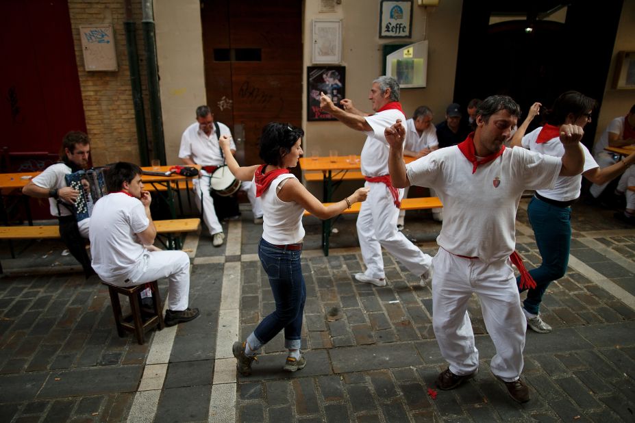 People dance while musicians play traditional music from the Basque country after lunch during the San Fermin festival on July 10.