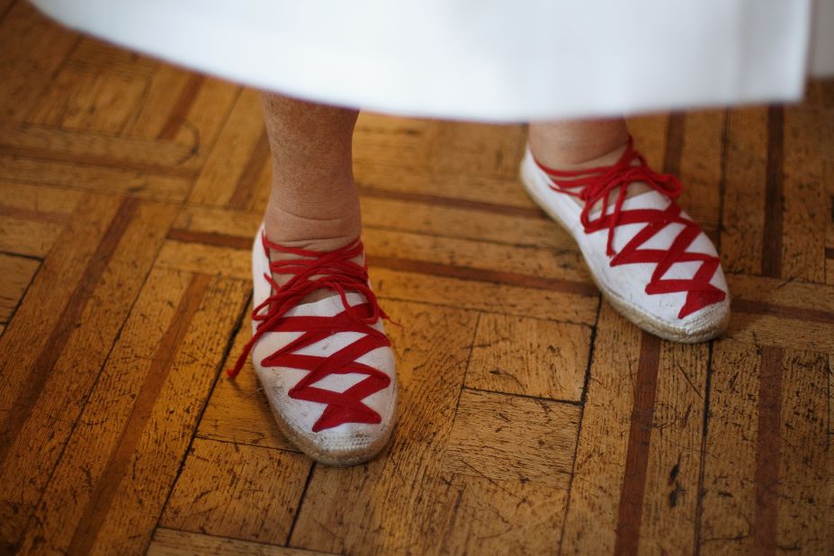 A woman wears a pair of red-laced espadrilles during El Baile de la Alpargata, a dance at the Casino Principal Club, in Pamplona on July 10.
