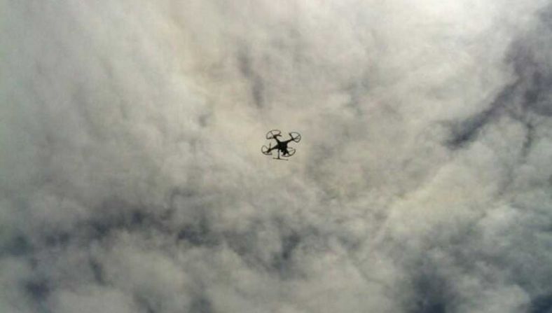 A remote-controlled "octocopter" belonging to the CNN team takes to the skies for an aerial shot of the mountain trail.