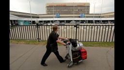 A man walks past Terminal F of Moscow's Sheremetyevo International Airport, where U.S. intelligence leaker Edward Snowden has been holed up since arriving June 23 from Hong Kong. The ex-National Security Agency contractor has admitted leaking classified documents about U.S. surveillance programs and faces espionage charges in the United States. In his first public appearance since arriving at Sheremetyevo, Snowden met with human rights activists and lawyers Friday, July 12, in the airport's transit zone. While it's still not clear if Russia will grant Snowden's temporary asylum request, he can leave the airport, Russian media report.