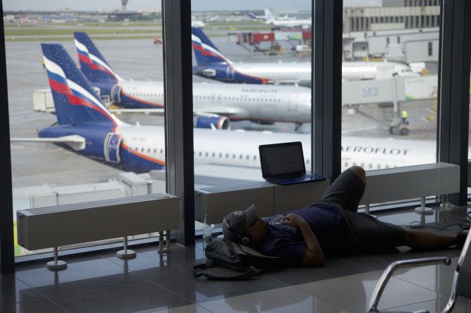 A passenger rests inside the airport on July 9.