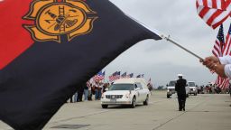  A hearse carrying the body of Christopher MacKenzie arrives at Los Alamitos Air Field, California, on July 10. MacKenzie was one of the 19 firefighters who lost their lives when they became trapped and their position overrun by flames from the Yarnell Hill Fire, southwest of Prescott on June 30. 