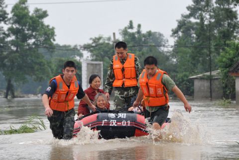 Rescuers use boats to relocate victims as the Tuo River floods Jintang county on July 11. The area is roughly 1,100 miles southwest of Beijing, the capital of China. 