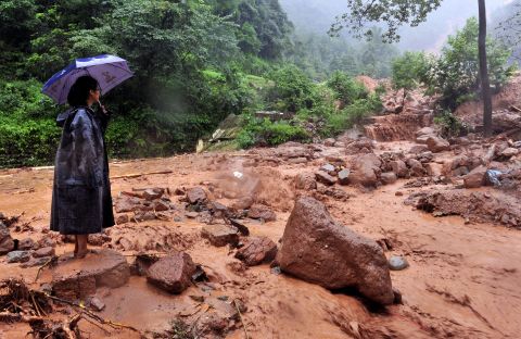 A woman looks on in the aftermath of the landslide in Dujiangyan on July 10.