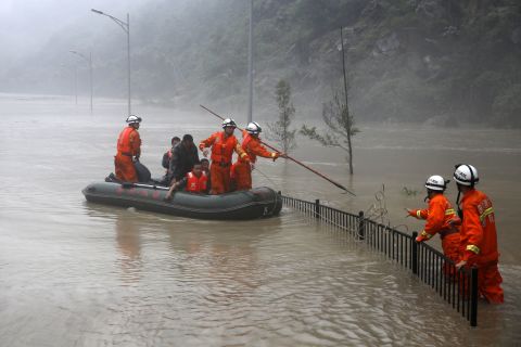 Rescuers search for victims as deep floodwaters sweep through Beichuan on July 9.