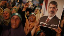 Egyptian supporters of the Muslim Brotherhood shout slogans in favour of Egypt's deposed president Mohamed Morsy (portrait) after breaking the fast outside Cairo's Rabaa al-Adawiya mosque on July 10, 2013, the first day of Islam's holy month of Ramadan.