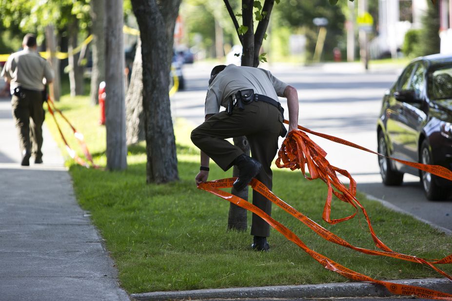 Police officers remove caution tape in areas of Lac-Megantic that were off-limits to residents. Since the July 6 derailment, wide areas of downtown have been restricted as authorities cleaned up and investigated the disaster site. 