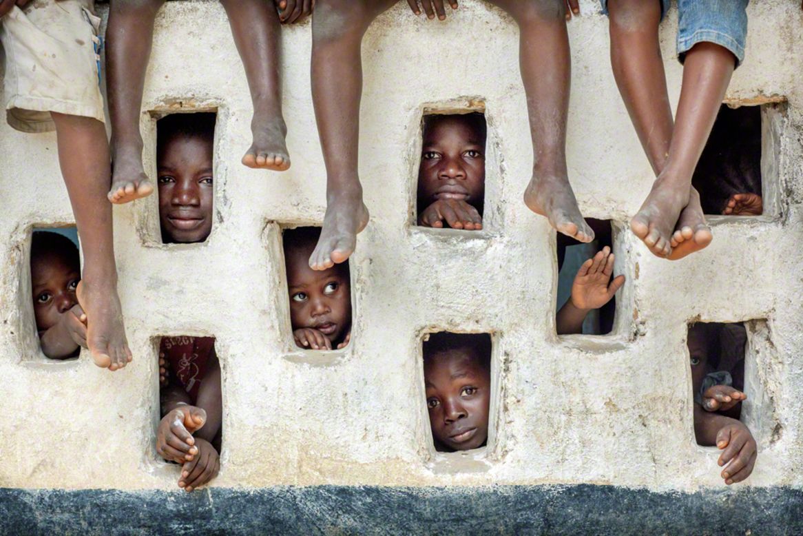 Grand Gedeh, Liberia: children watch an Oxfam team at work; Timothy Allen, U.K.; Best Single Image in People Watching portfolio.