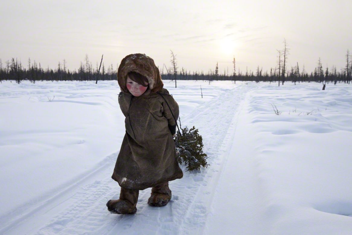 Siberia, Russia: young Nenet girl collects wood in the forest; Alessandra Meniconzi, Switzerland; winner, New Talent award. A self-taught, semi-professional photographer, Meniconzi's portfolio mixed "gritty reality with great beauty," the judges said.