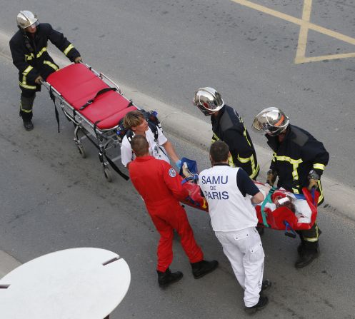 Emergency crews help transport a victim from the scene of the accident on July 12. 