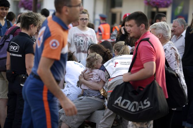 Injured passengers wait to receive medical treatment on July 12 at the Bretigny-sur-Orge station, where the train derailed. 