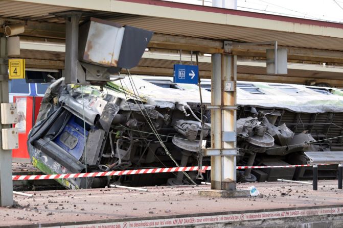 A train car lies on its side at Bretigny-sur-Orge station on July 12.