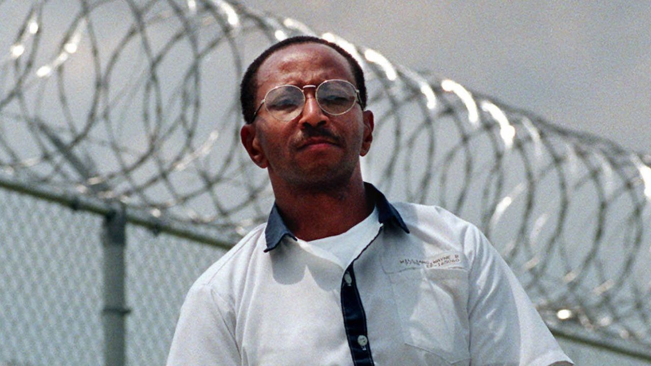 Wayne Williams poses along the fence line at Valdosta State Prison, Valdosta, Georgia, in 1999.