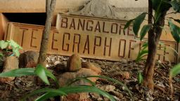 A derelict name board for the Bangalore Telegraph office lies on the ground outside the premises in Bangalore, India, on June 13, 2013. On July 15, 2013, the Indian government will discontinue the 162-year-old service. 
