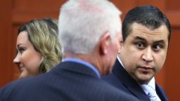 SANFORD, FL - JULY 12: George Zimmerman (R), Seminole court services investigator Rob Hemmert and George Zimmerman's wife Shellie Zimmerman (L), stand in the courtroom during George Zimmerman's murder trial July 12, 2013 in Sanford, Florida. Judge Debra Nelson has ruled that the jury can also consider a lesser manslaughter charge along with the second-degree murder charge in the shooting death of Trayvon Martin. (Photo by Joe Burbank-Pool/Getty Images)
