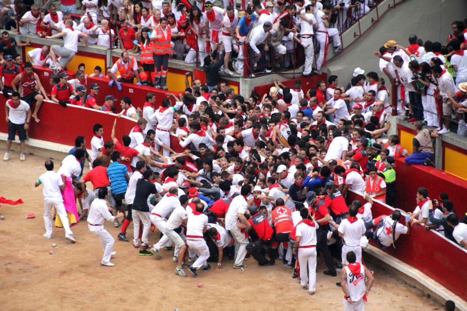 Runners clog the entrance to the bull ring in Pamplona ahead of several bulls on July 13. The resulting clash between revelers and bulls resulted in several injuries.
