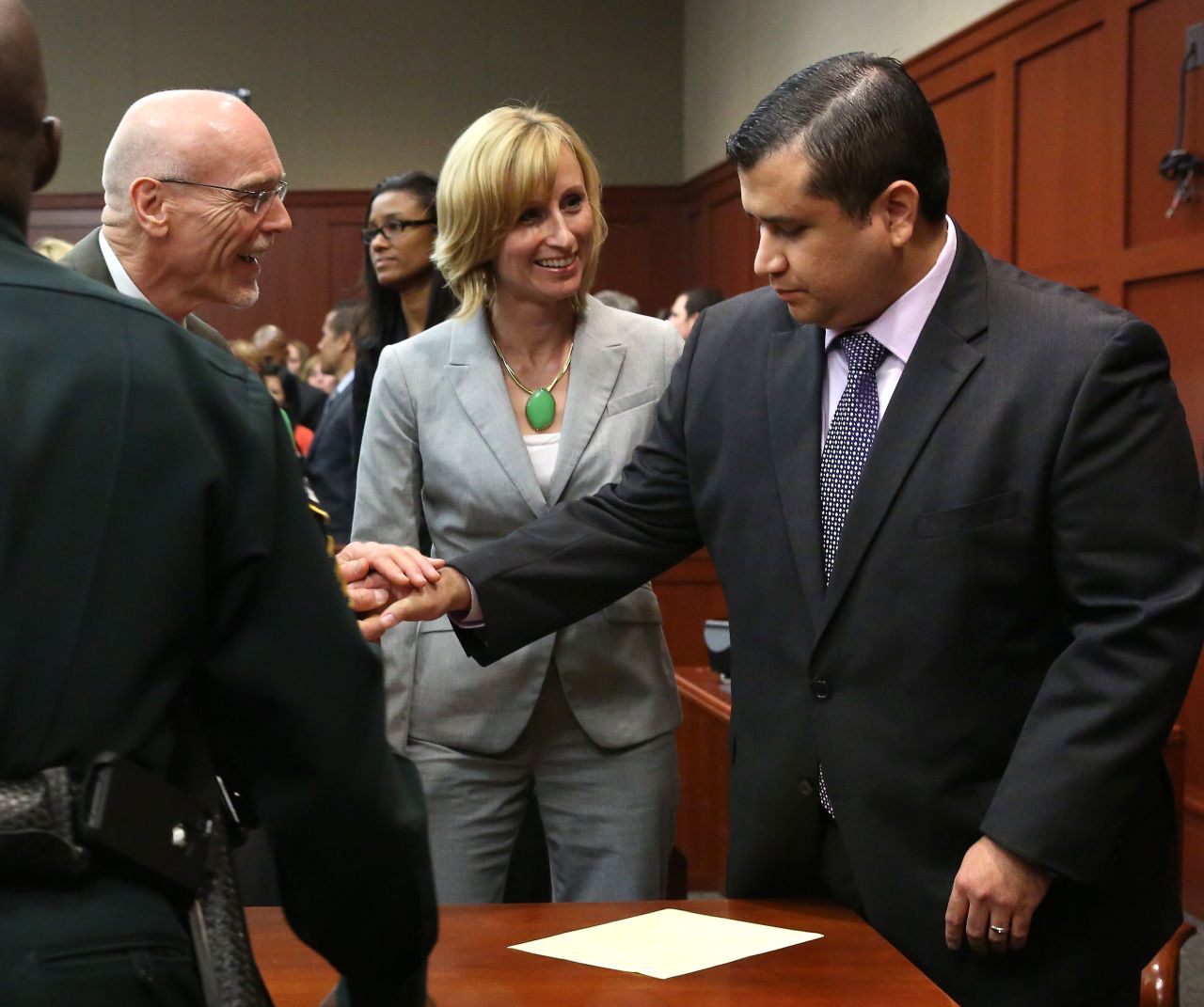 George Zimmerman is congratulated by members of his defense team, Don West and Lorna Truett, after the not guilty verdict is read on Saturday, July 13, in Sanford, Florida. A jury of six women found him  not guilty in the shooting death of Trayvon Martin. <a href="http://www.cnn.com/2013/07/13/justice/gallery/zimmerman-trial-reaction/index.html" target="_blank">View photos of the public reaction to the verdict.</a>
