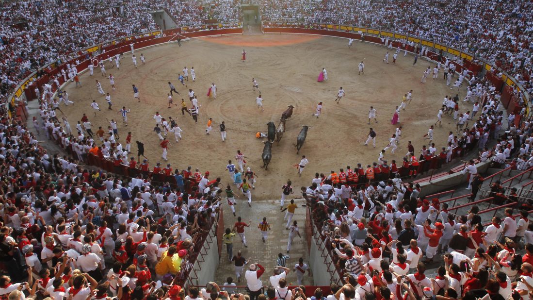 Bulls chase revelers during the final running of the bulls at the San Fermin festival in Pamplona, Spain, on Sunday, July 14. The annual festival of San Fermin involves letting the bulls loose through the historic heart of the city. The nine-day festival ends Sunday.