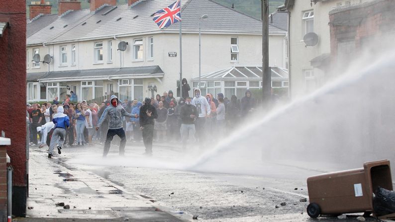 Police fire a water cannon at a crowd on July 13.