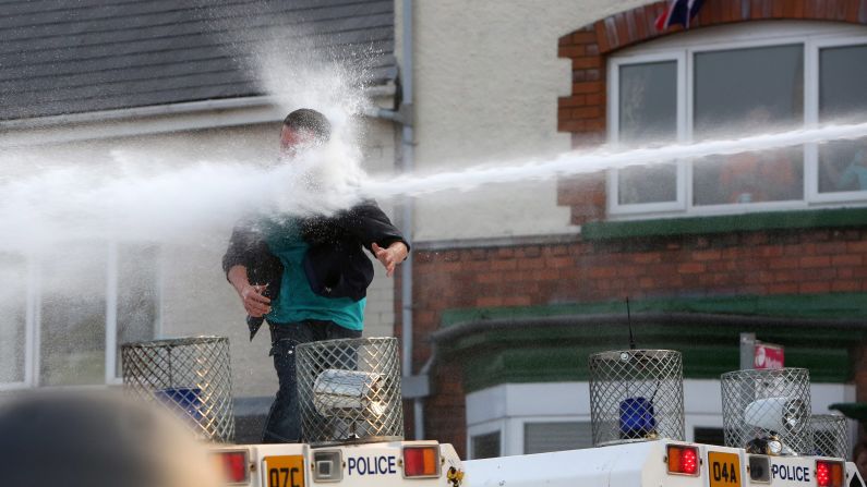 A man is hit by a water cannon in on July 12.